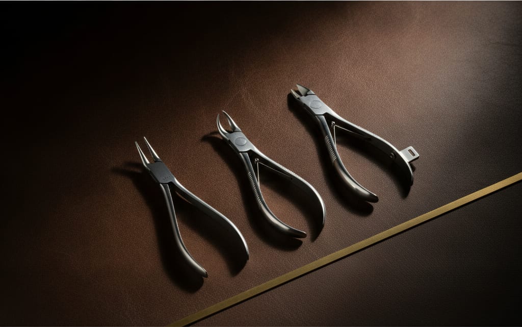 Orthodontic bonding and bracket instruments on an espresso leather surface